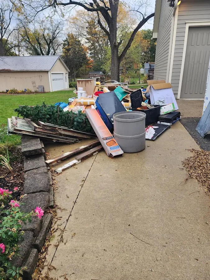 Dumpster being loaded with debris for Roofing Dumpster Rental in Dudley